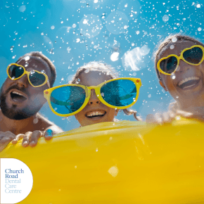 a man woman and child with large yellow sunglasses smiling in a swimming pool