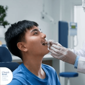 A teenage boy having his teeth checked at the dentist